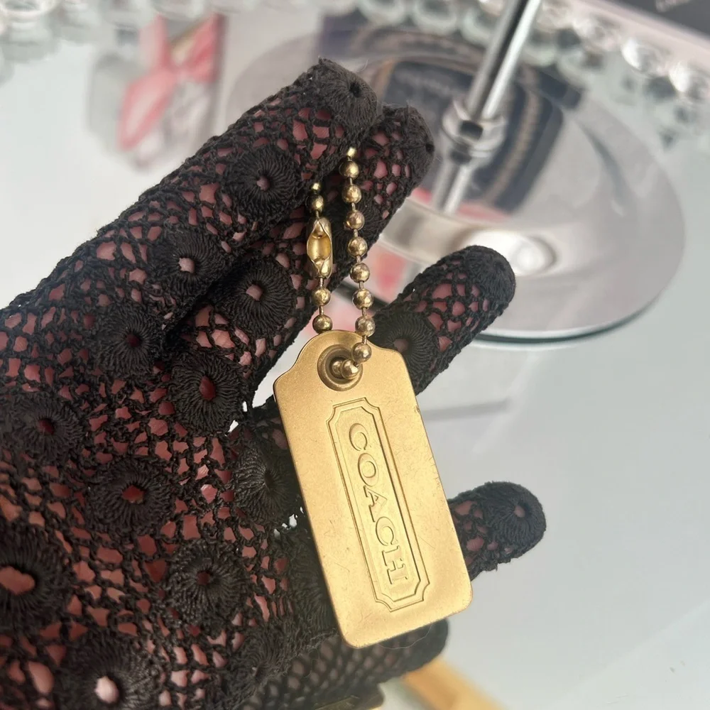 Coach color brass  metal tag